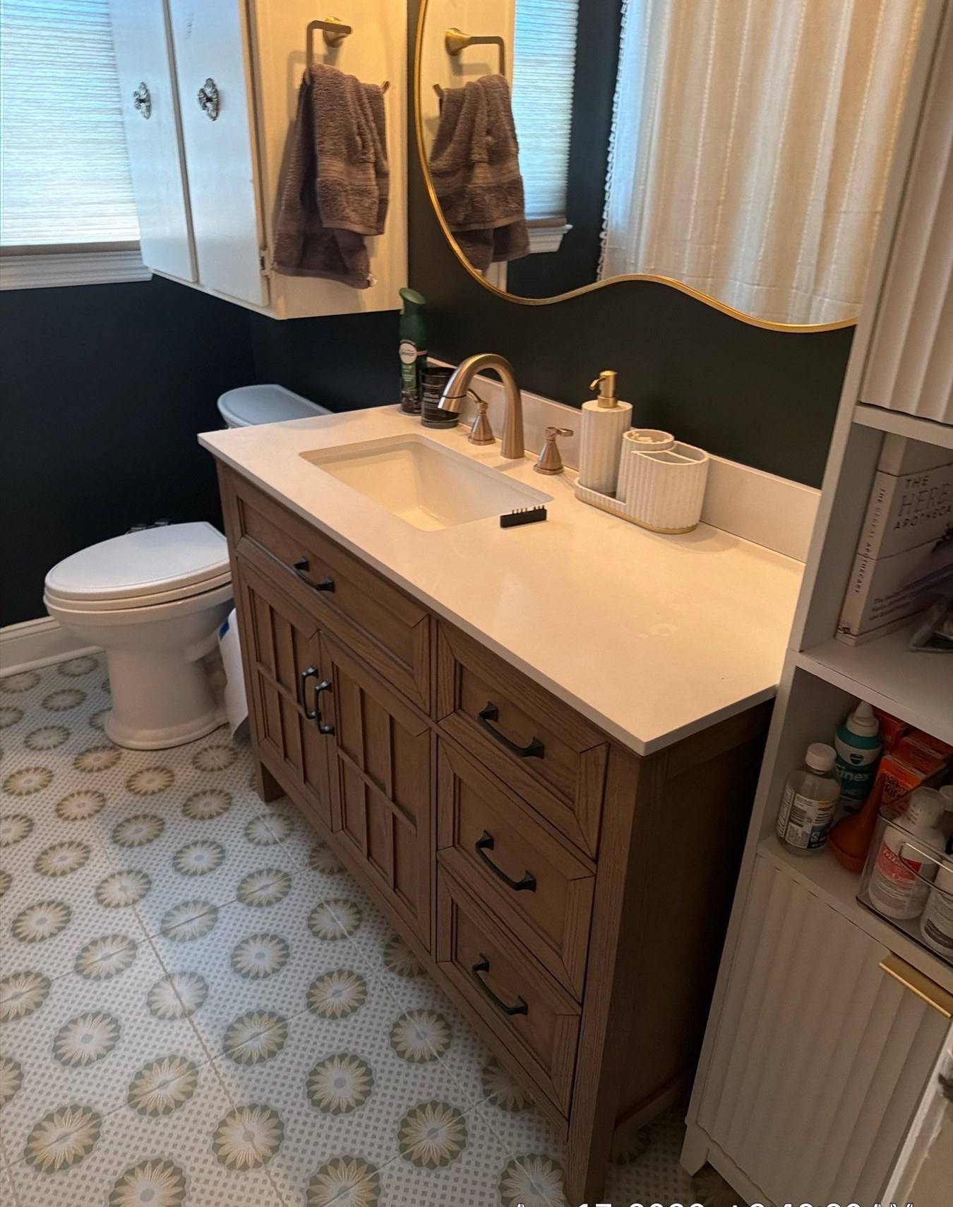 Remodeled bathroom with patterned tile floor and wood vanity in Cayce, SC