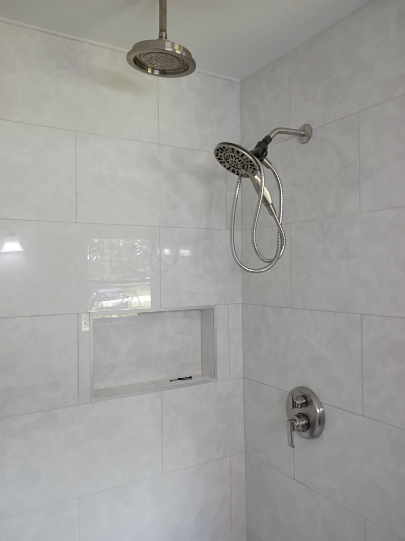 New tiled shower with a built in niche in a renovated bathroom in Cope, SC
