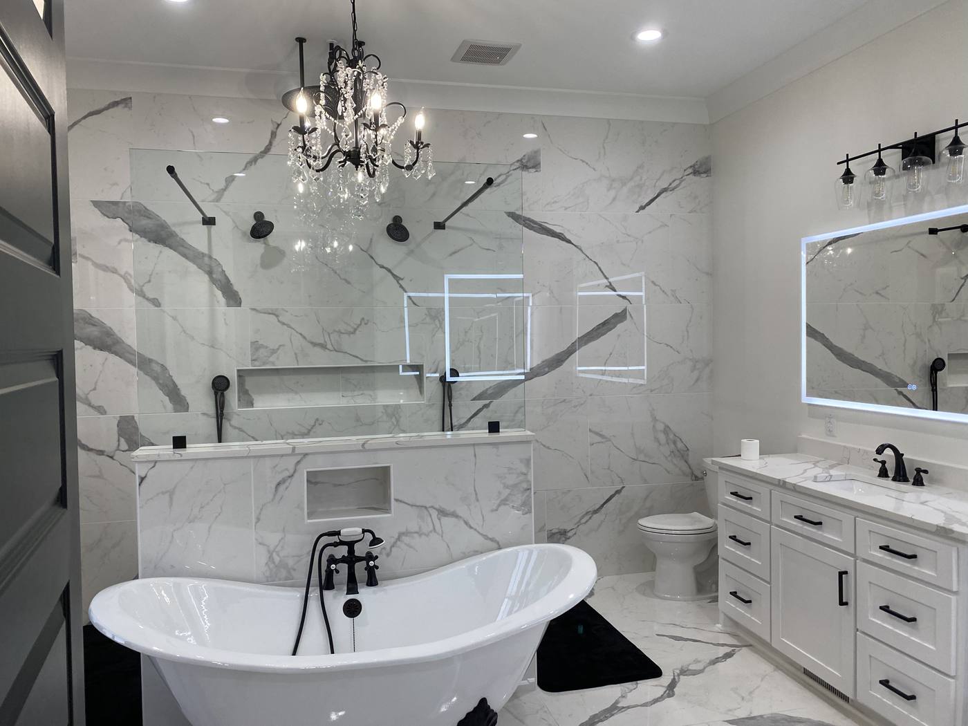 Marble tile primary bathroom with a freestanding tub, glass shower and double vanity in the Midlands of South Carolina