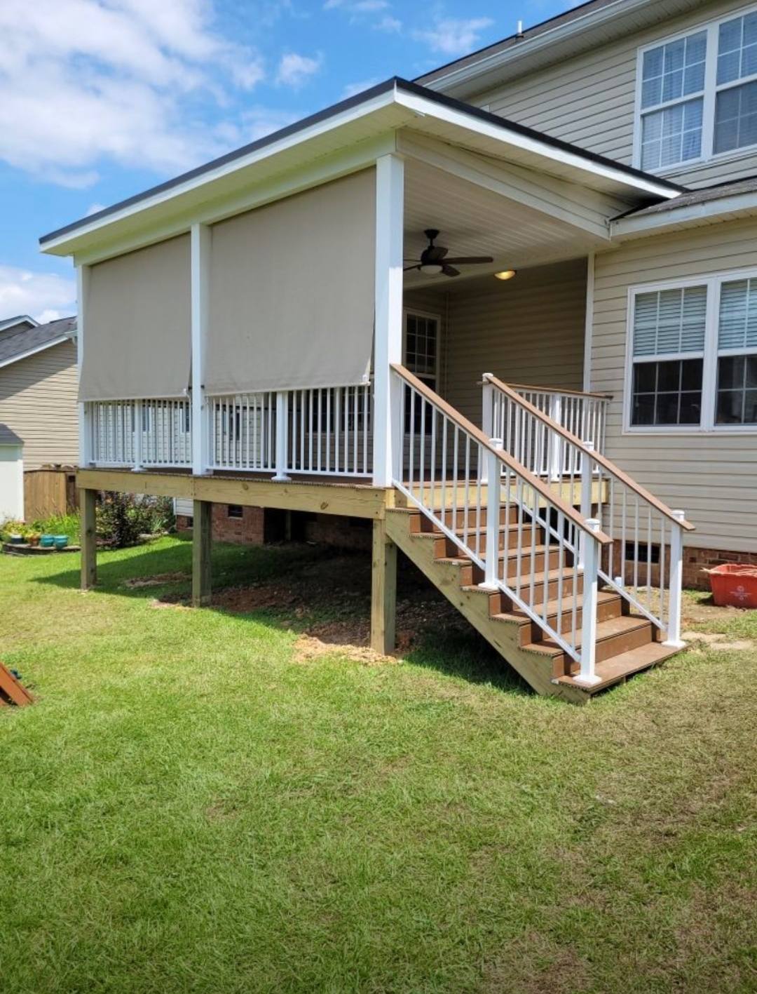 Elevated covered deck with painted railings and a full stair run in the Midlands of South Carolina