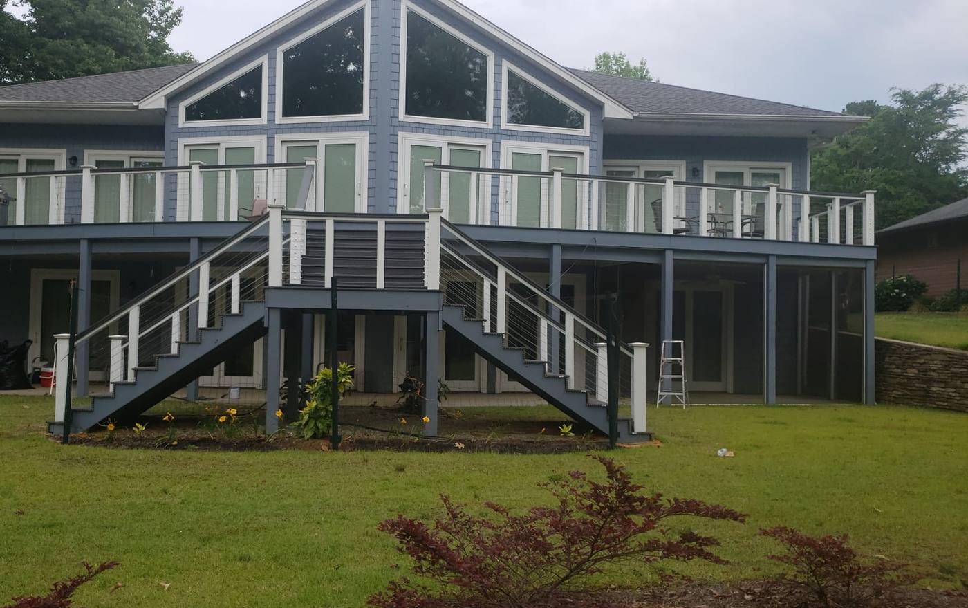 Two-story deck with dual stair runs and dark railings on a rear elevation in the Midlands of South Carolina