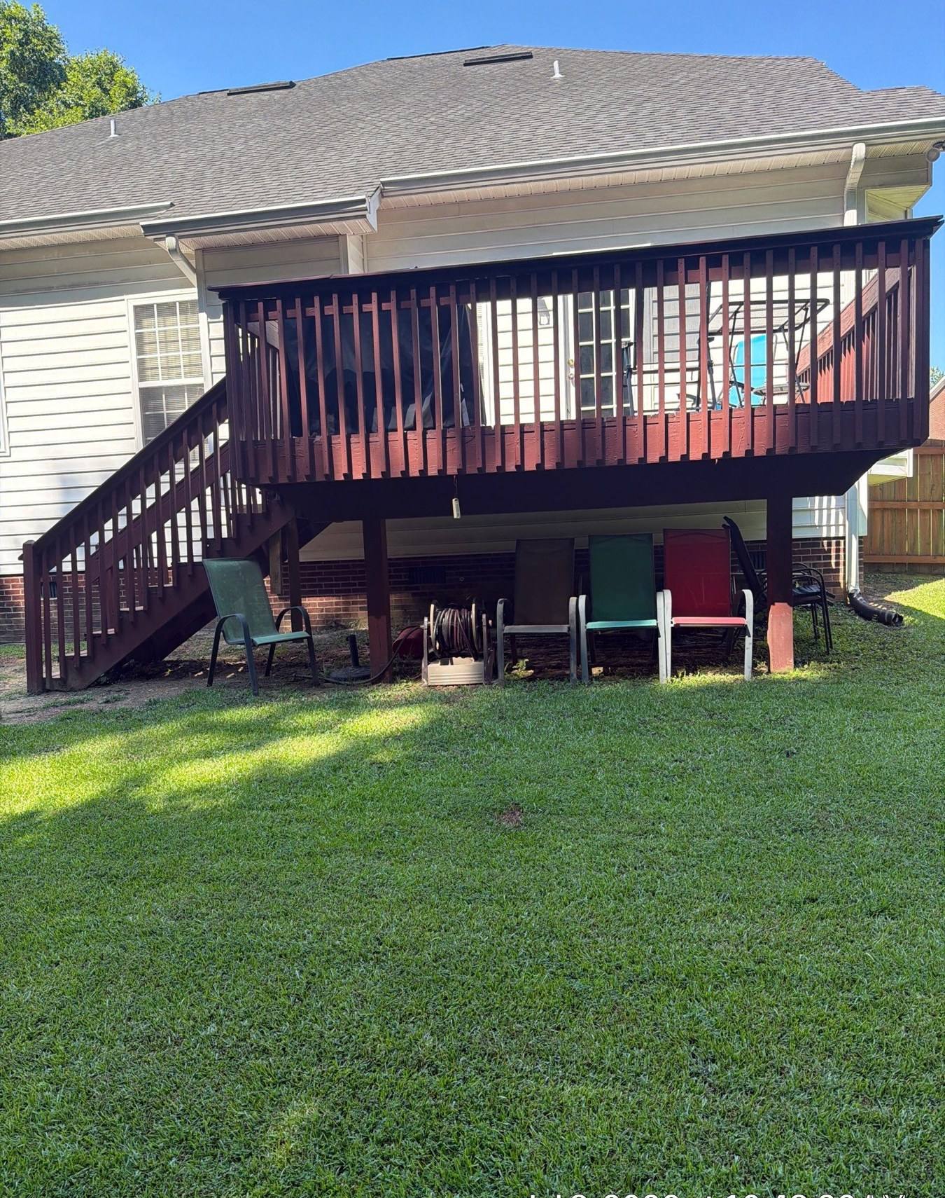 Aging stained wood deck before replacement in Lexington, SC