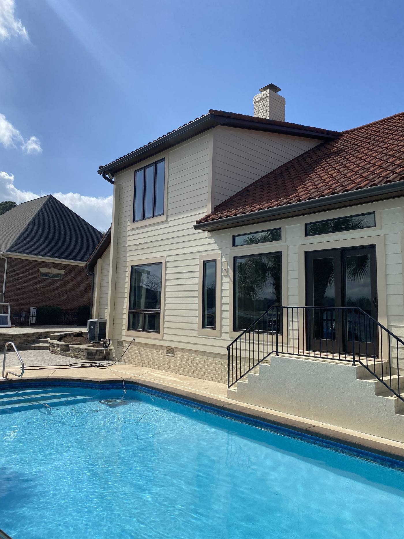 Rear elevation with a clay tile roof and pool in the Midlands of South Carolina