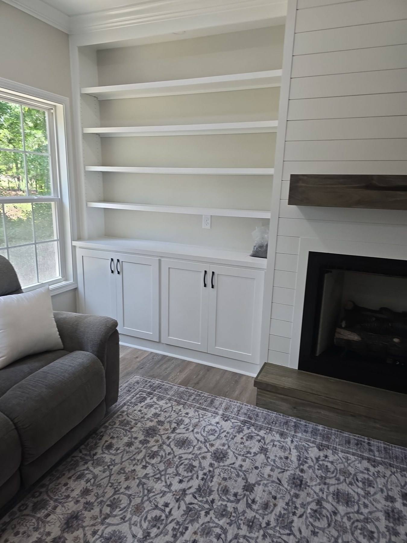 Custom built-ins flanking a fireplace in a finished home addition