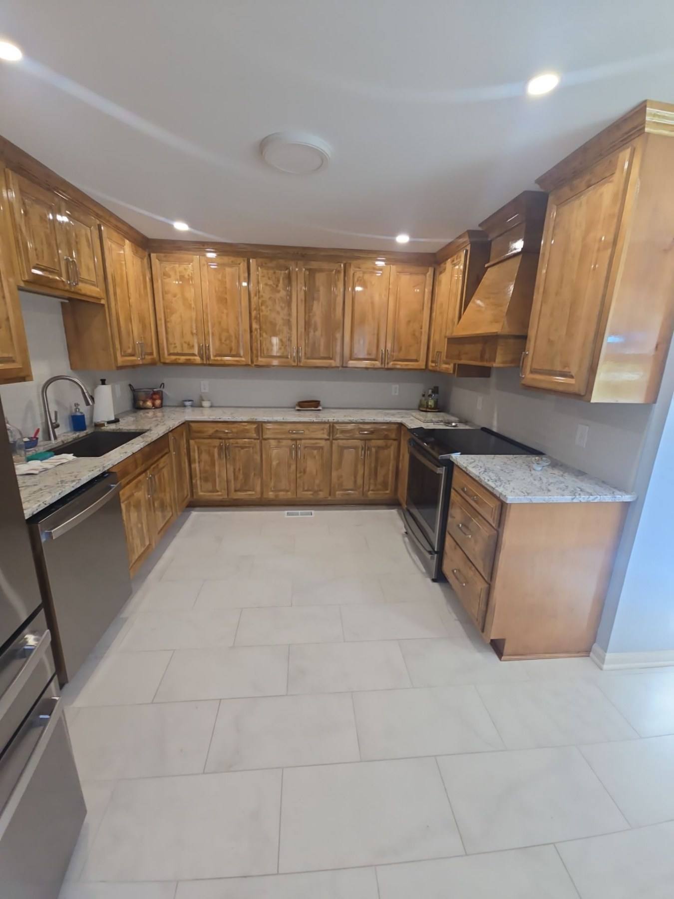 Renovated U-shaped kitchen with alder cabinetry, granite counters and tile flooring in Cope, SC