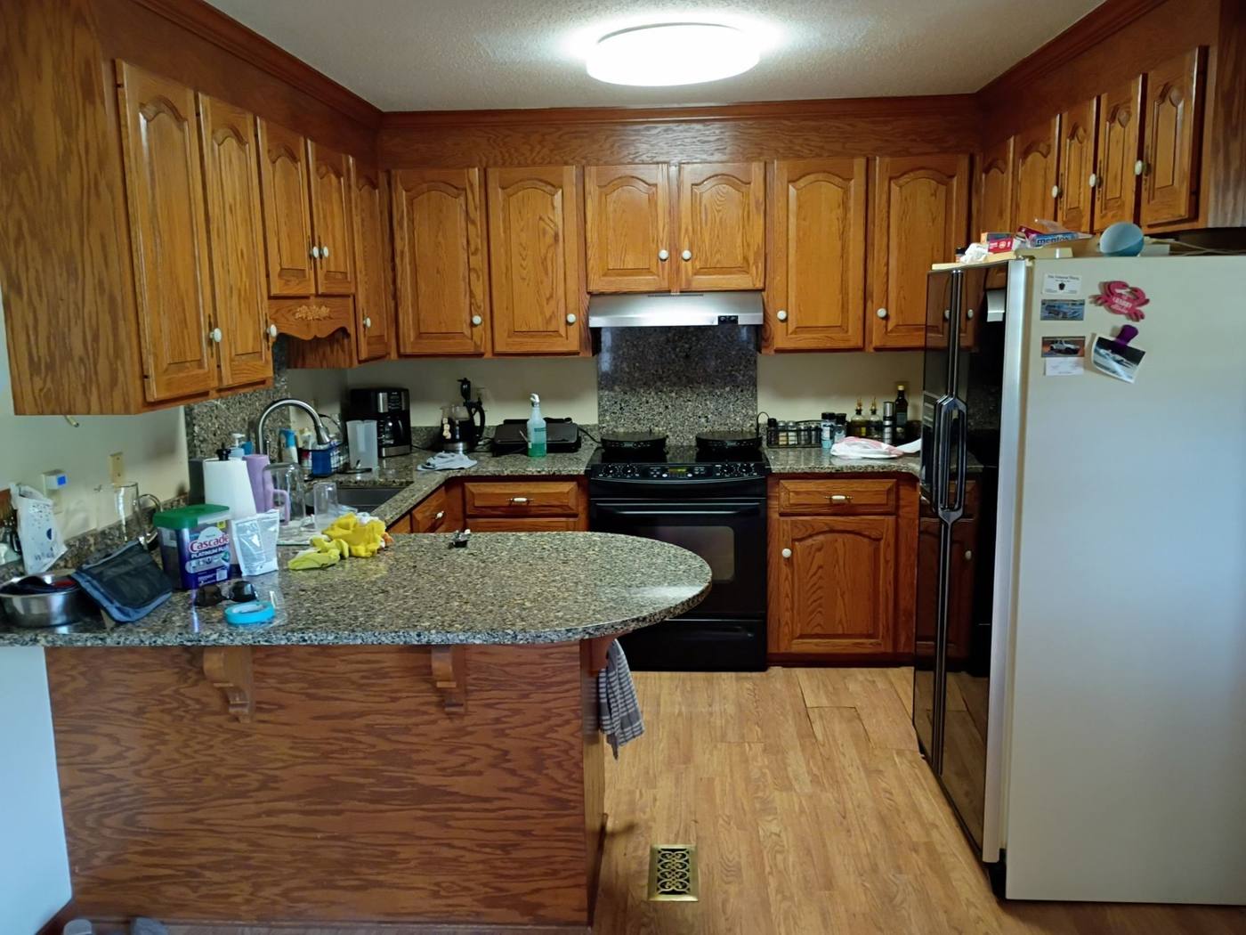 Dated oak kitchen with a peninsula before renovation in Cope, SC