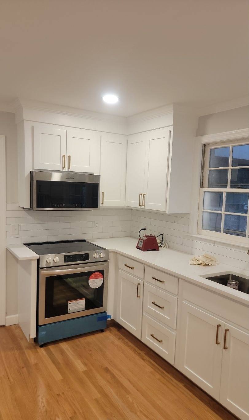 New range, cabinetry and tile backsplash in a remodeled Forest Acres kitchen