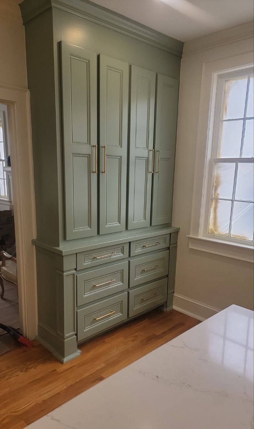Custom green cabinetry and pantry in a rebuilt kitchen in Shandon, Columbia