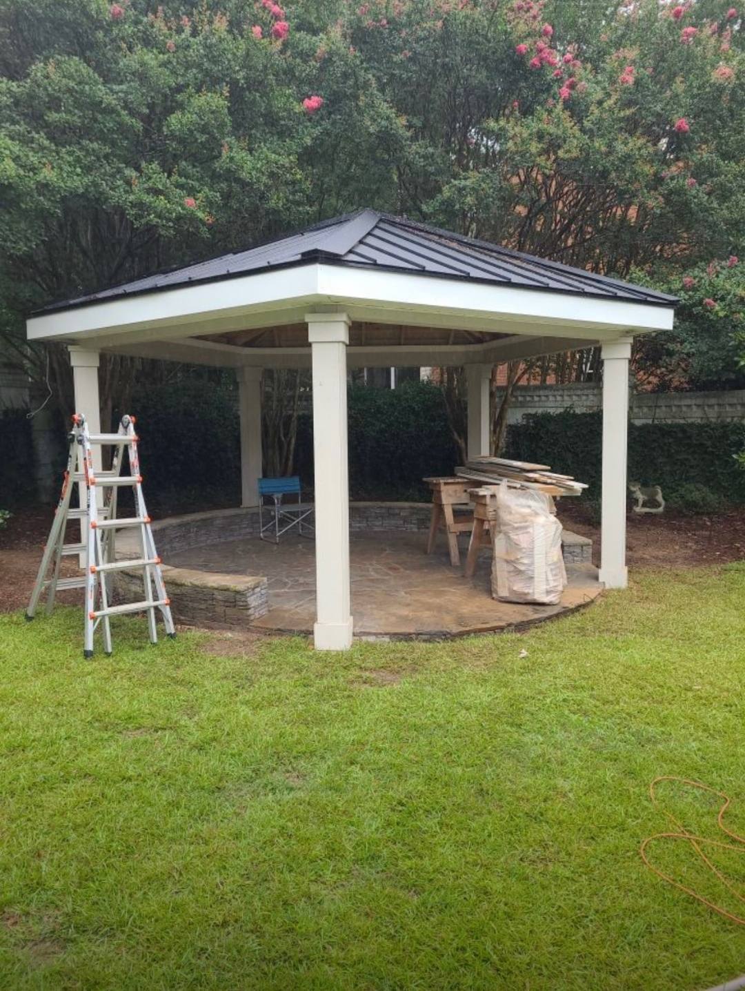 Freestanding backyard pavilion with a hip roof and paver floor in the Midlands of South Carolina