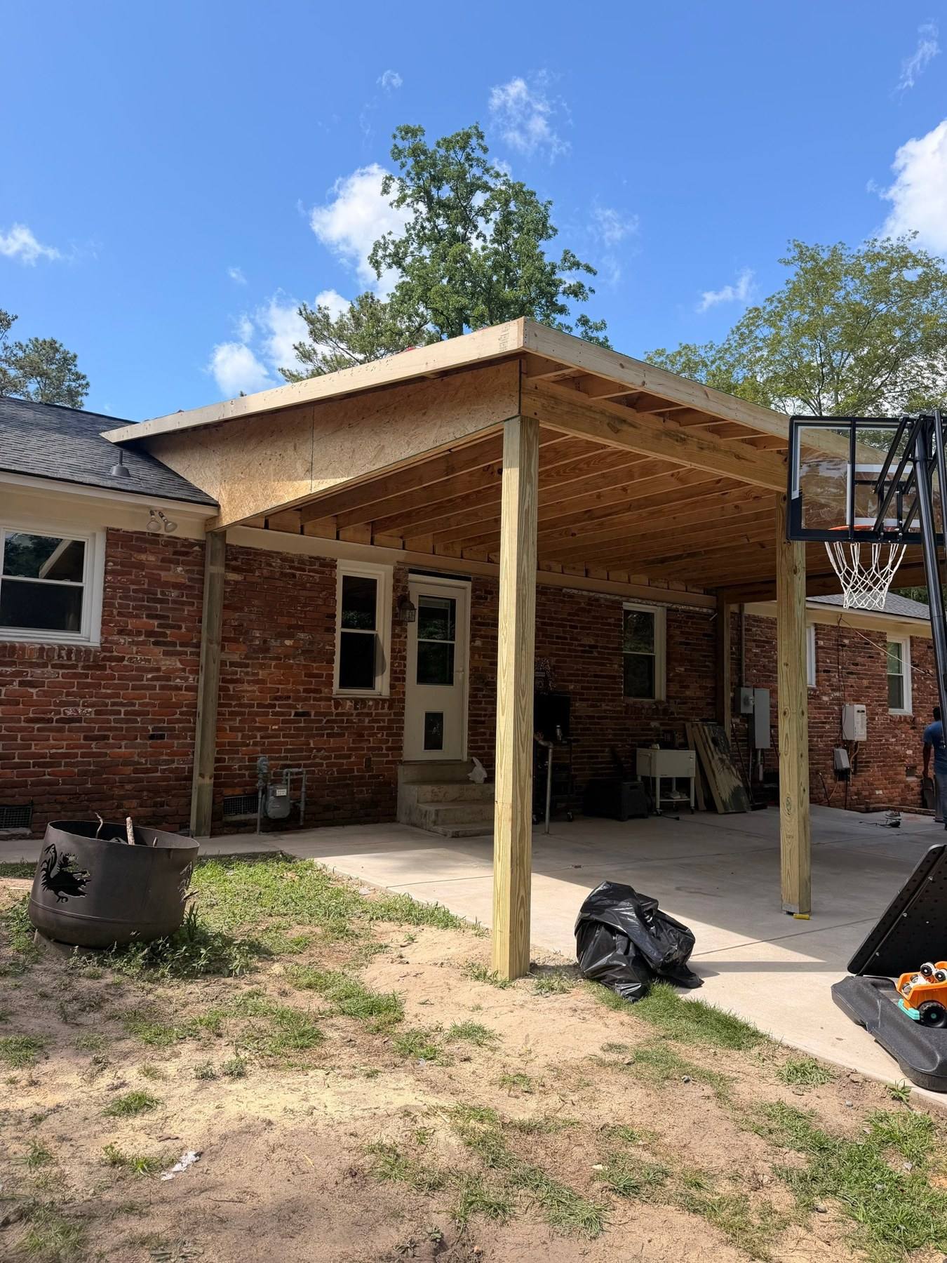 New wood-framed covered porch with shingle roof in Columbia, SC