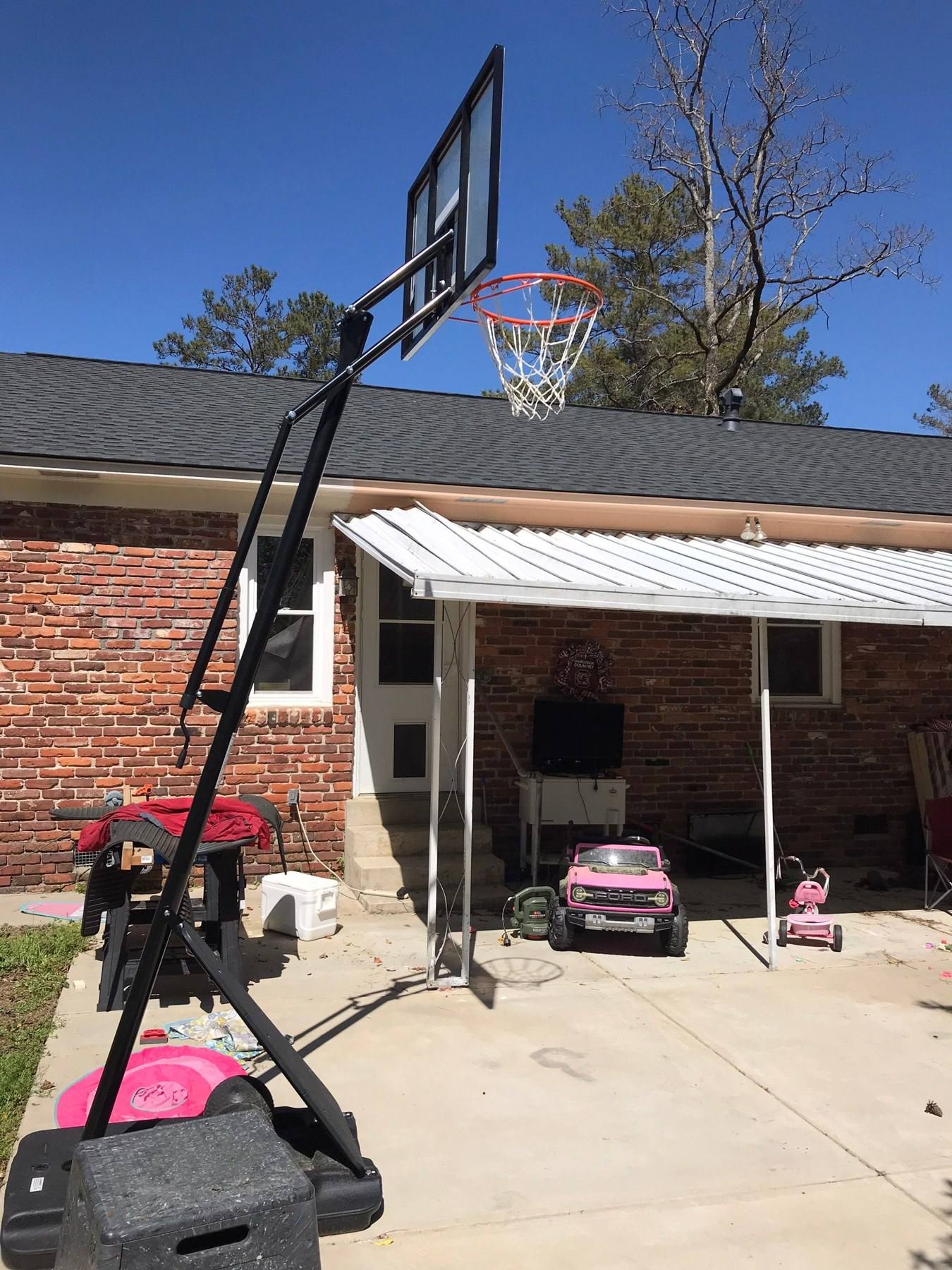 Old metal awning carport before a covered porch build in Columbia, SC