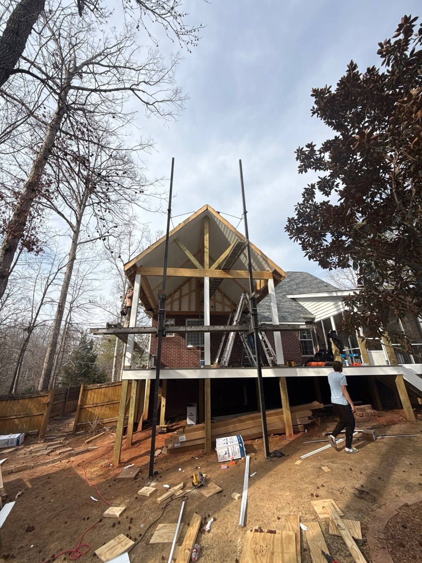 Framing and roof structure going up on a screened porch rebuild in Lexington, SC