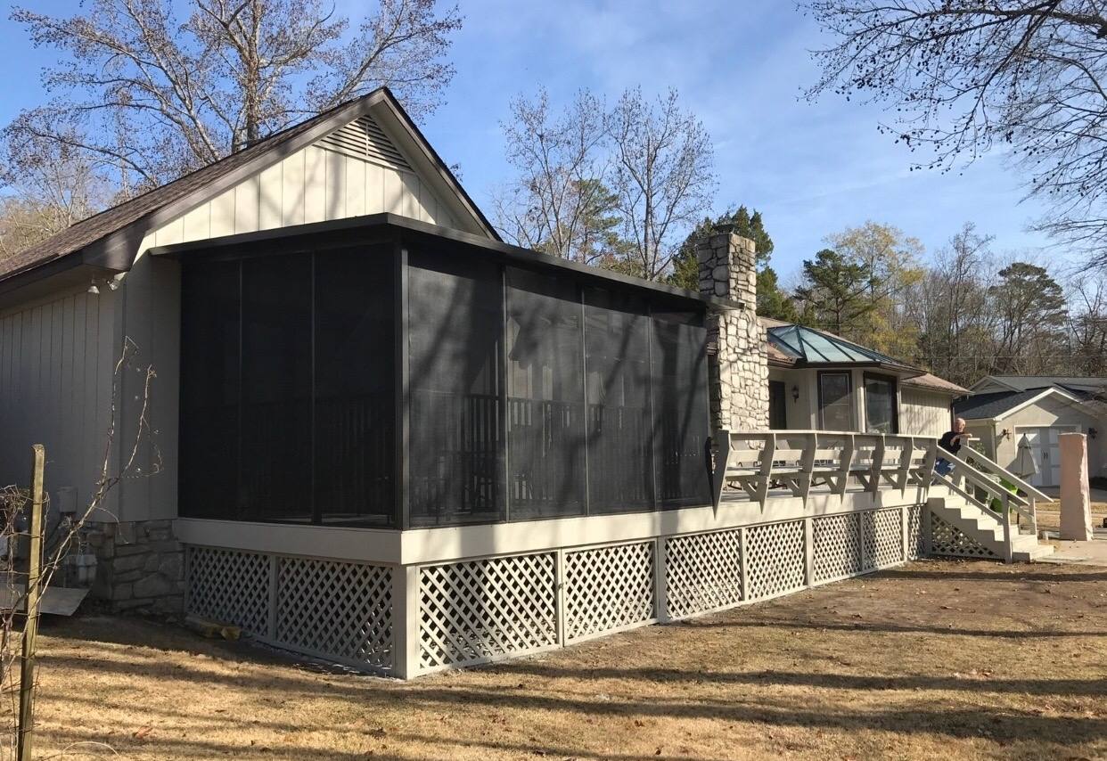 Screened porch addition with lattice skirting on a brick home in the Midlands of South Carolina
