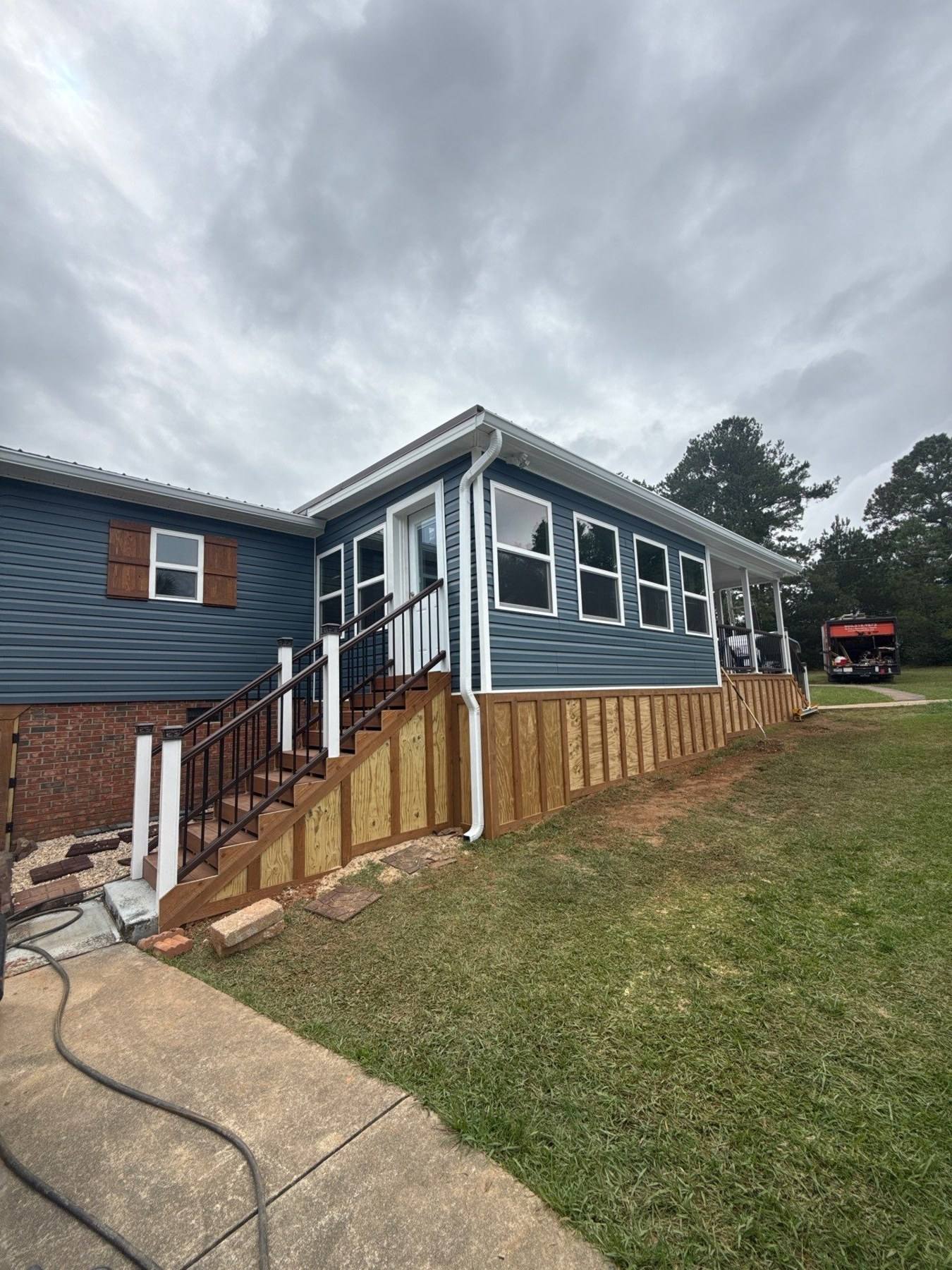 Completed exterior renovation with new siding and deck in Prosperity, SC