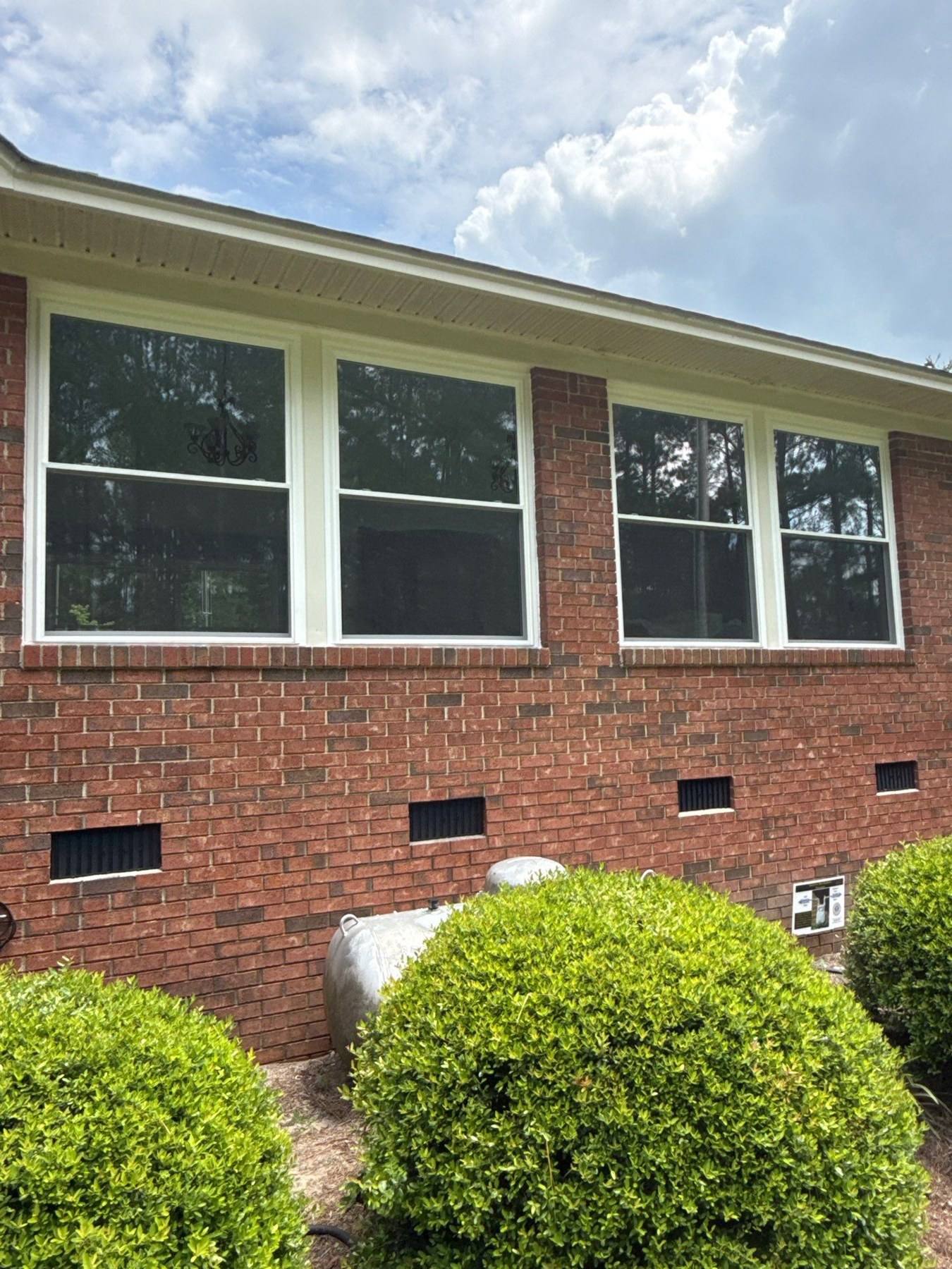 New windows installed on a brick ranch during renovation in Cope, SC